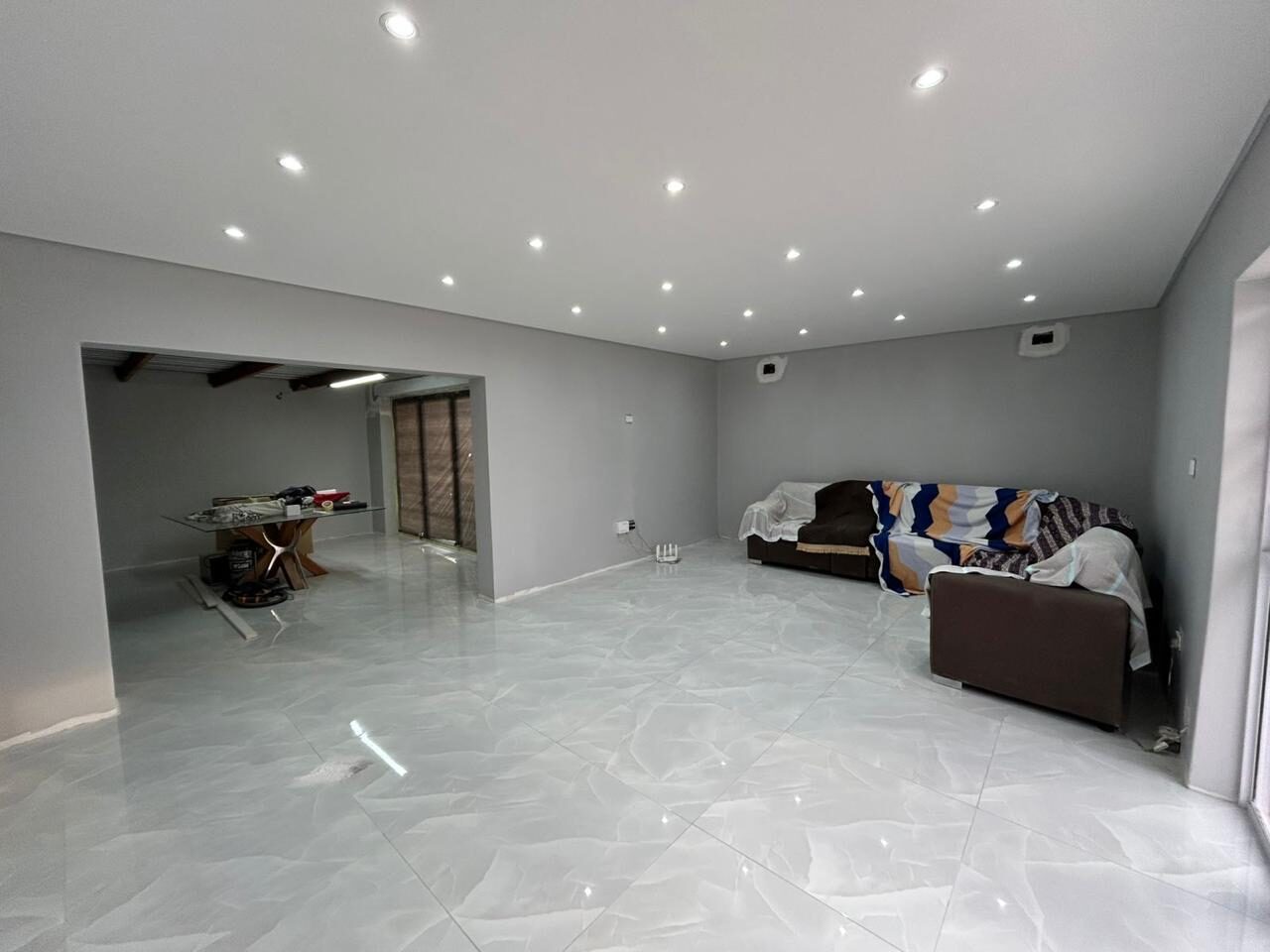 The finished living area — painted, tiled and ready to hand over