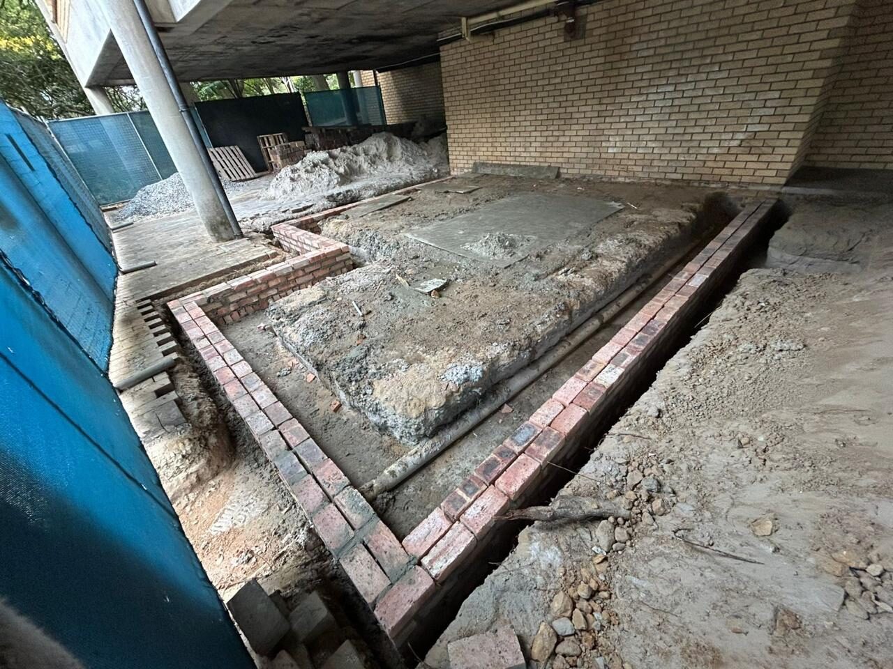 New foundation and brick footing course, freshly cast concrete
