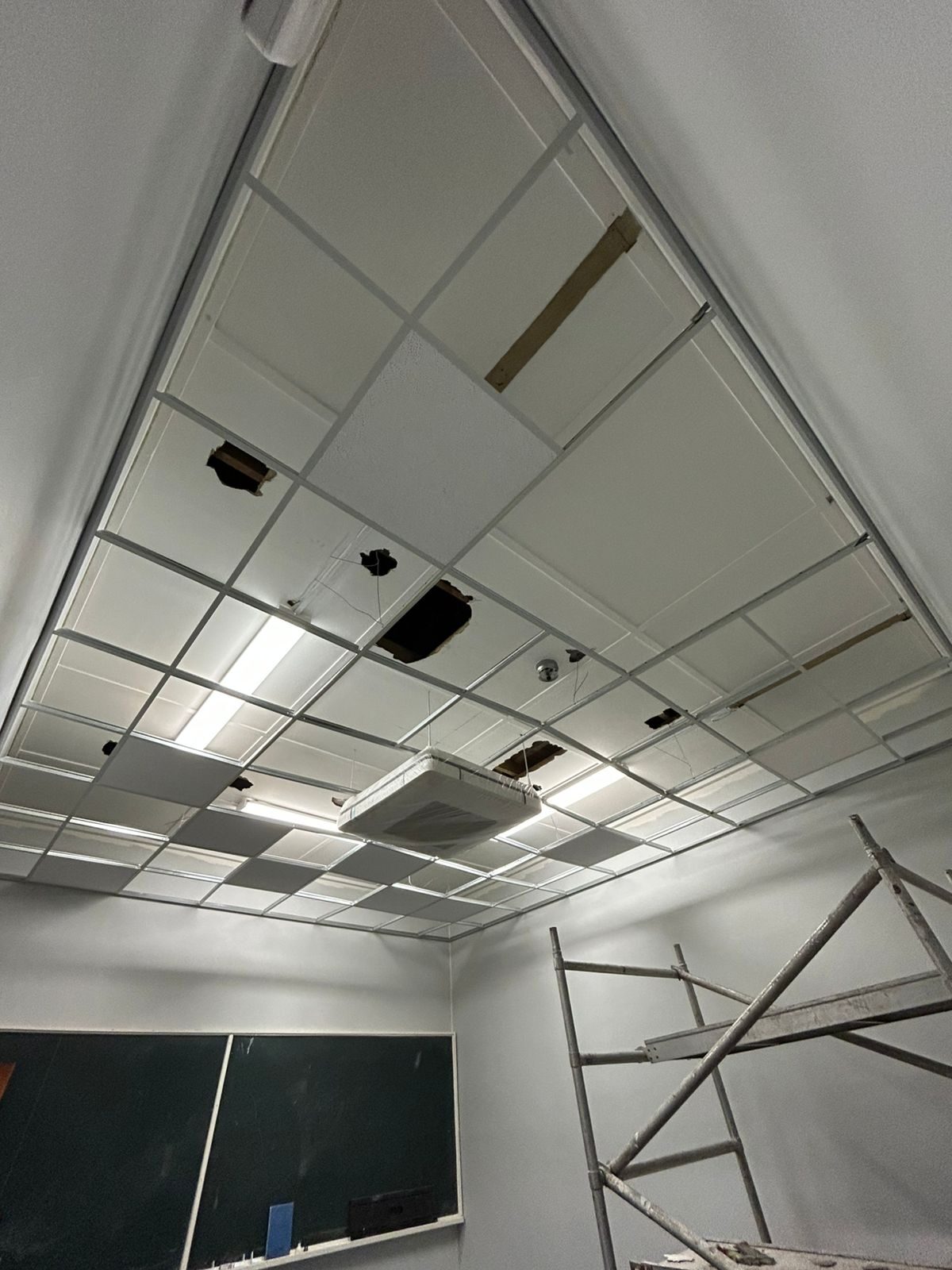 Suspended ceiling grid and ducting under installation