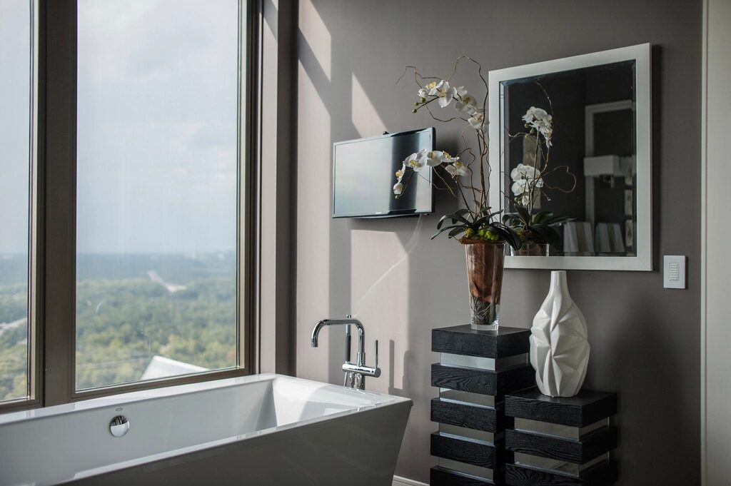 Indicative reference: a freestanding bath against a painted feature wall beside a picture window