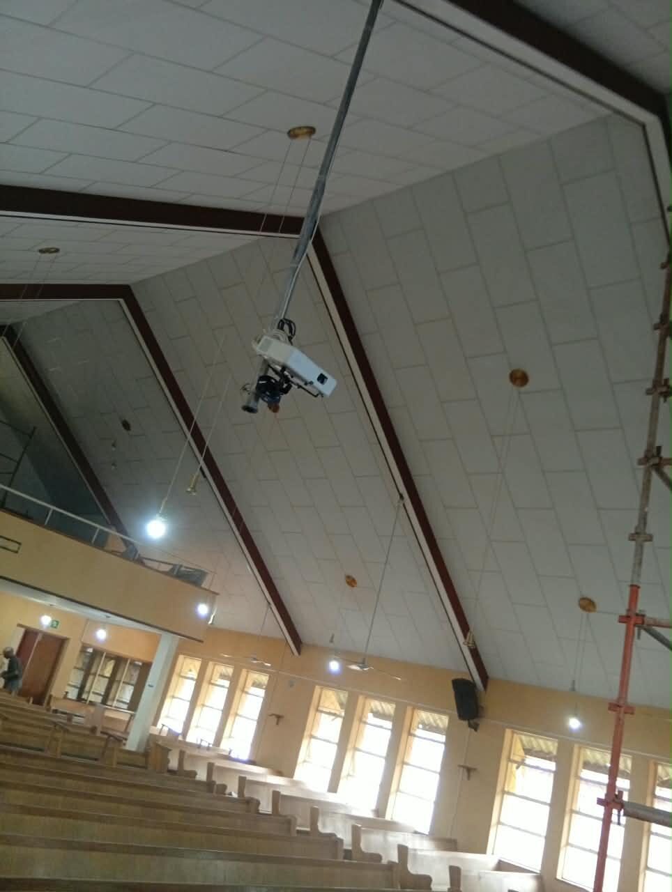 The completed ceiling &mdash; new boarding between the stained timber beams, with the gallery and arched windows below
